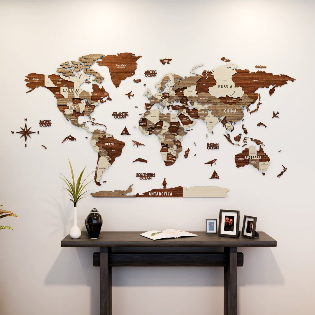 World map wall decoration on a plain wall with a wooden table below.