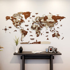 Multicolor wooden world map with country names above a dark console table with framed photos