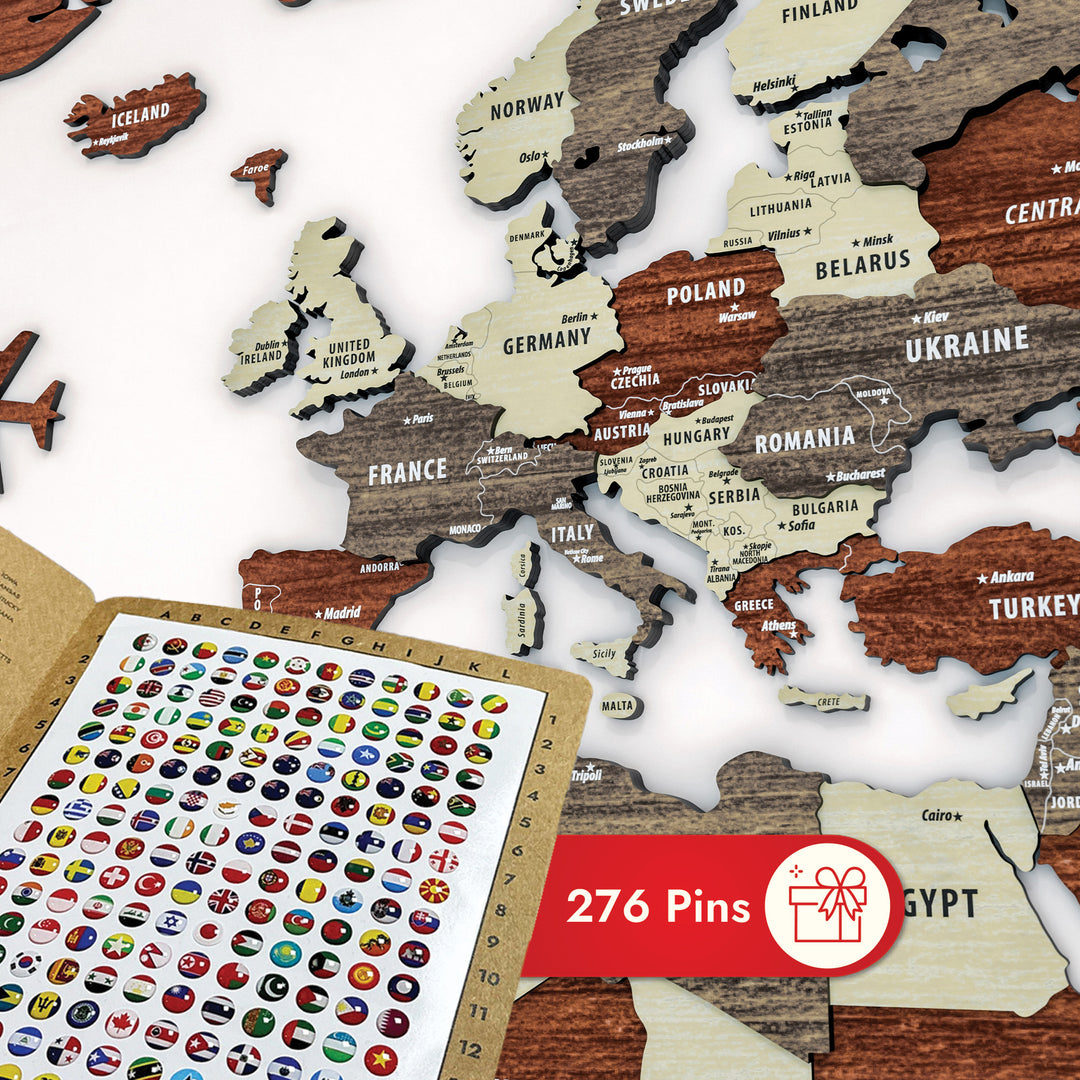 World map puzzle with wooden pieces and a sheet of country flags on a white background.