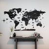 World map wall decal on a light gray wall above a wooden desk.