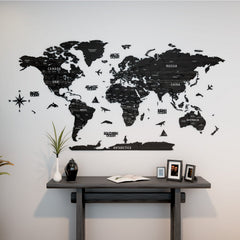 Tuana wooden world map with country names above a dark console table with framed photos