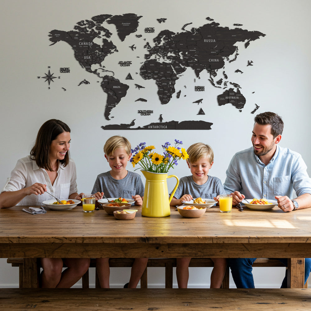 Family of four sitting at a dining table with a world map on the wall behind them.
