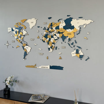 Yellow wooden world map viewed from the left with Australia and Antarctica, black sideboard edge at the bottom