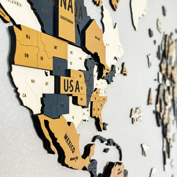 Angled close-up of the yellow wooden world map showing the western USA states and Mexico in raised layers