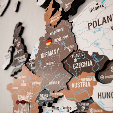 Close-up of Germany, Czechia and Austria with a flag pin on the Soil wooden world map