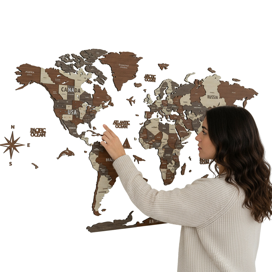 Woman pointing at a wooden world map on a white background