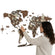 Woman pointing at a wooden world map on a white background