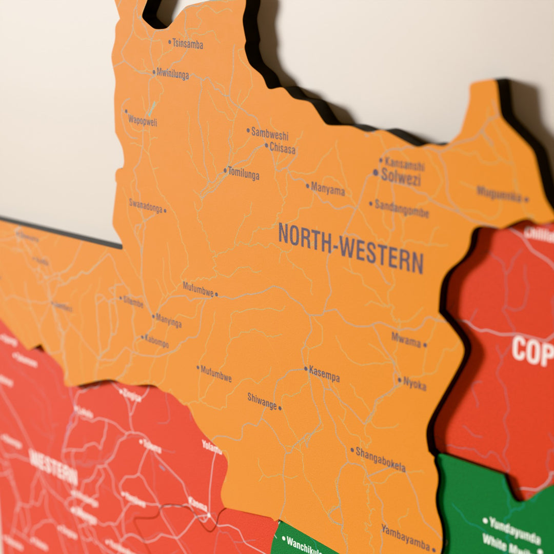 Close-up of the Flag colored Zambia wooden wall map with layered regions and printed names