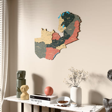 Sage Zambia wooden wall map beside a sheer curtain, angled view