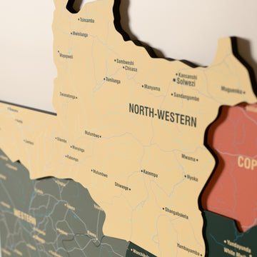 Close-up of the Sage Zambia wooden wall map with layered regions and printed names