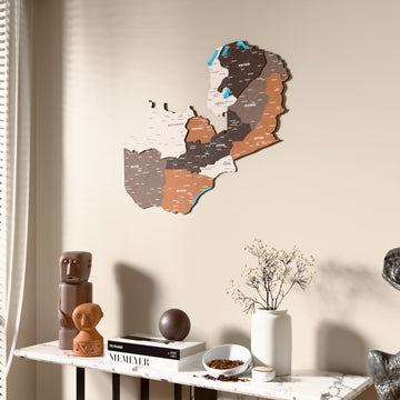 Soil Zambia wooden wall map beside a sheer curtain, angled view