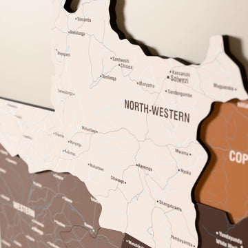 Close-up of the Soil Zambia wooden wall map with layered regions and printed names