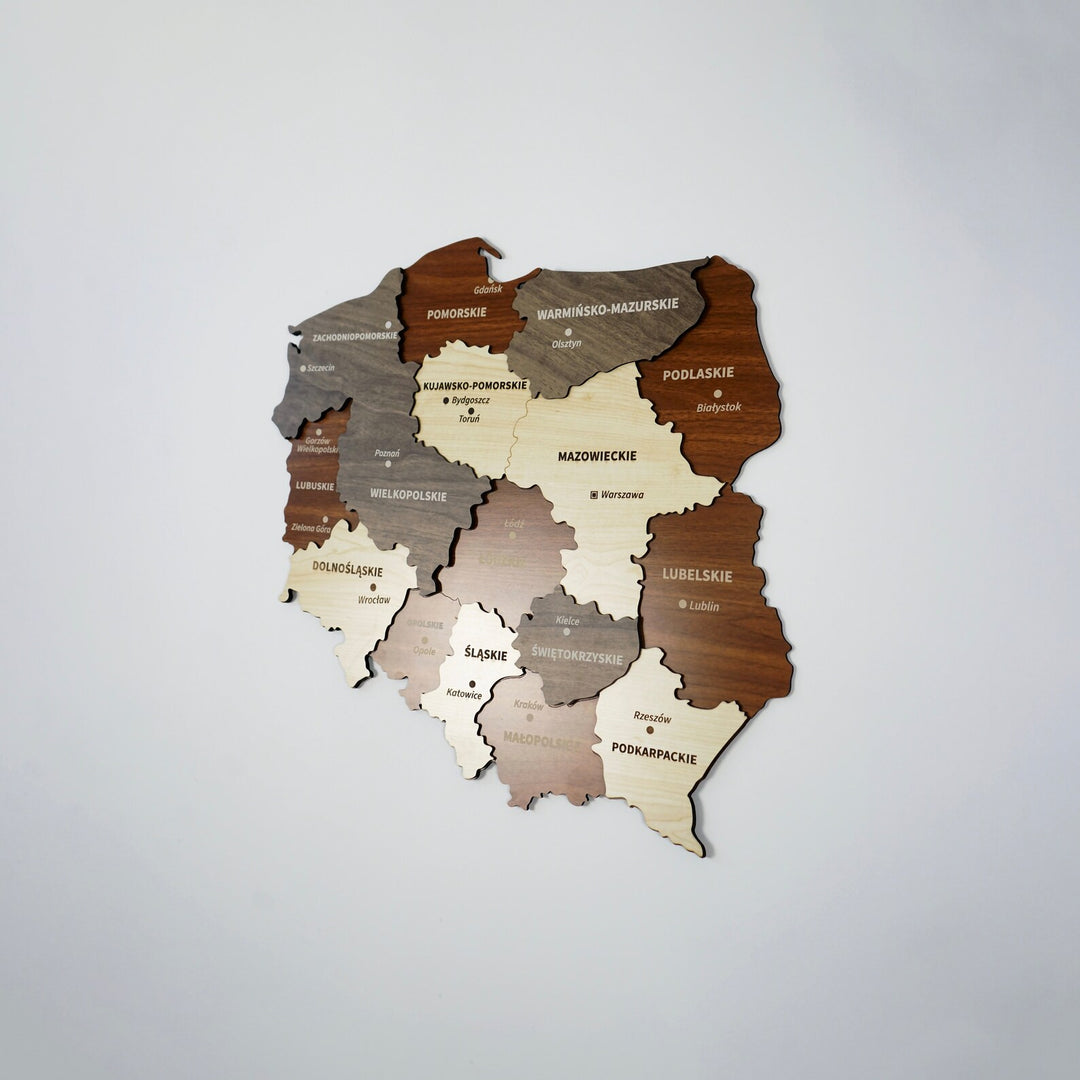 Small Poland wooden wall map with voivodeship names, angled view on a plain wall