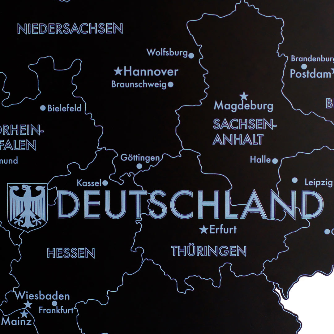 Close-up of the black metal Germany map with Deutschland logo, Hannover, Wolfsburg and Magdeburg