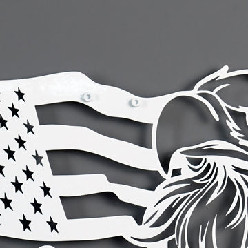 Close-up of white metal flag stripes, stars and eagle feathers on the We The People wall art