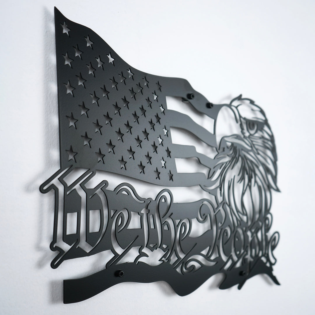 Black We The People US flag metal wall art, angled close view of the stars, eagle and lettering